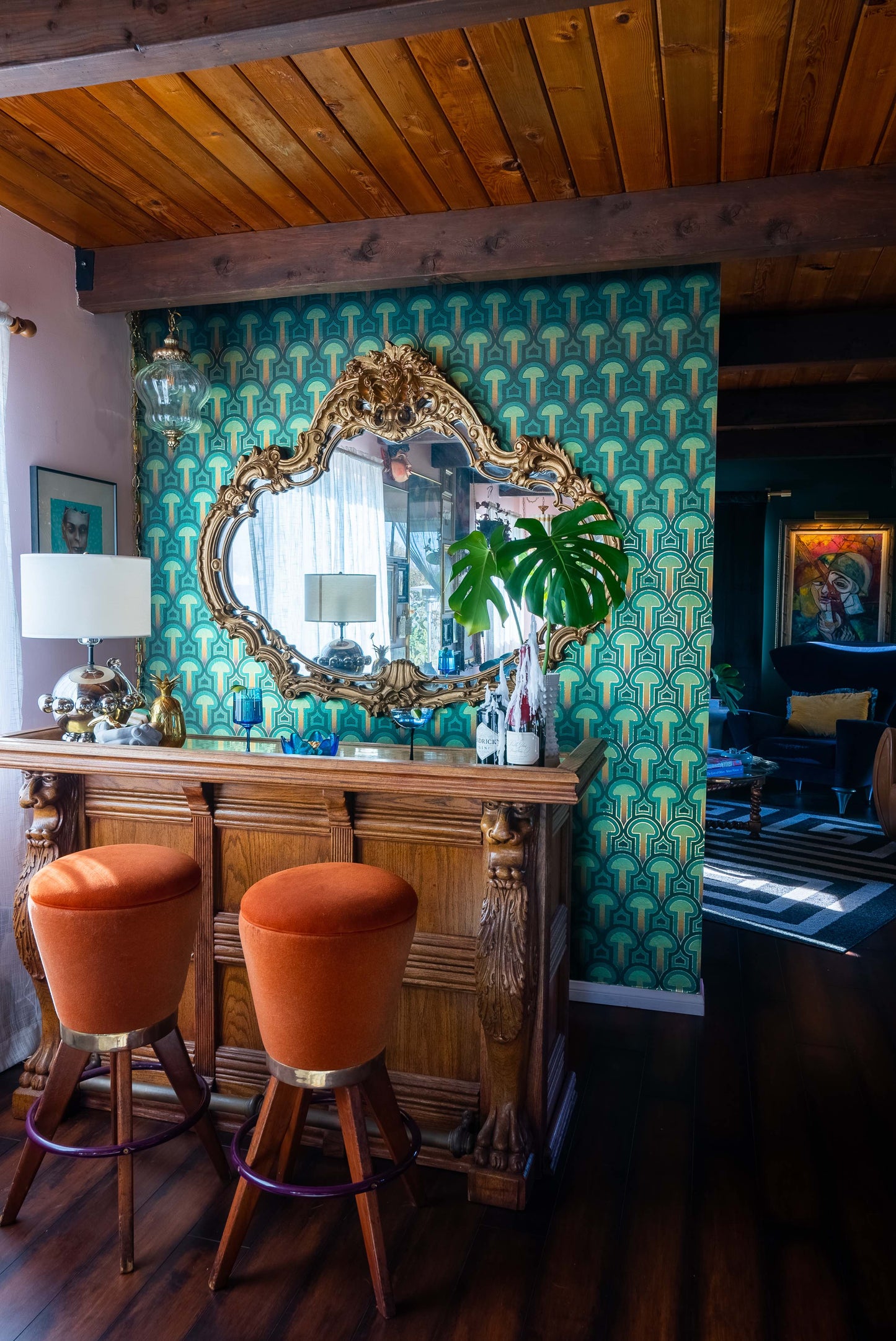 Enlightenment 'Psilocybe' Wallcovering as an accent wall behind a carved wooden home bar.