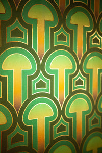 Installation of Enlightenment Psilocybe wallpaper on narrow staircase in Nicole Hollis designed private maximalist house. Enlightenment Psilocybe is a shimmering repeat geometric pattern featuring mushrooms and the portals of discovery they inspire, in blues, blue greens, a teal to gold sunset inspired ombre, all outlined in gold and printed on gold mylar