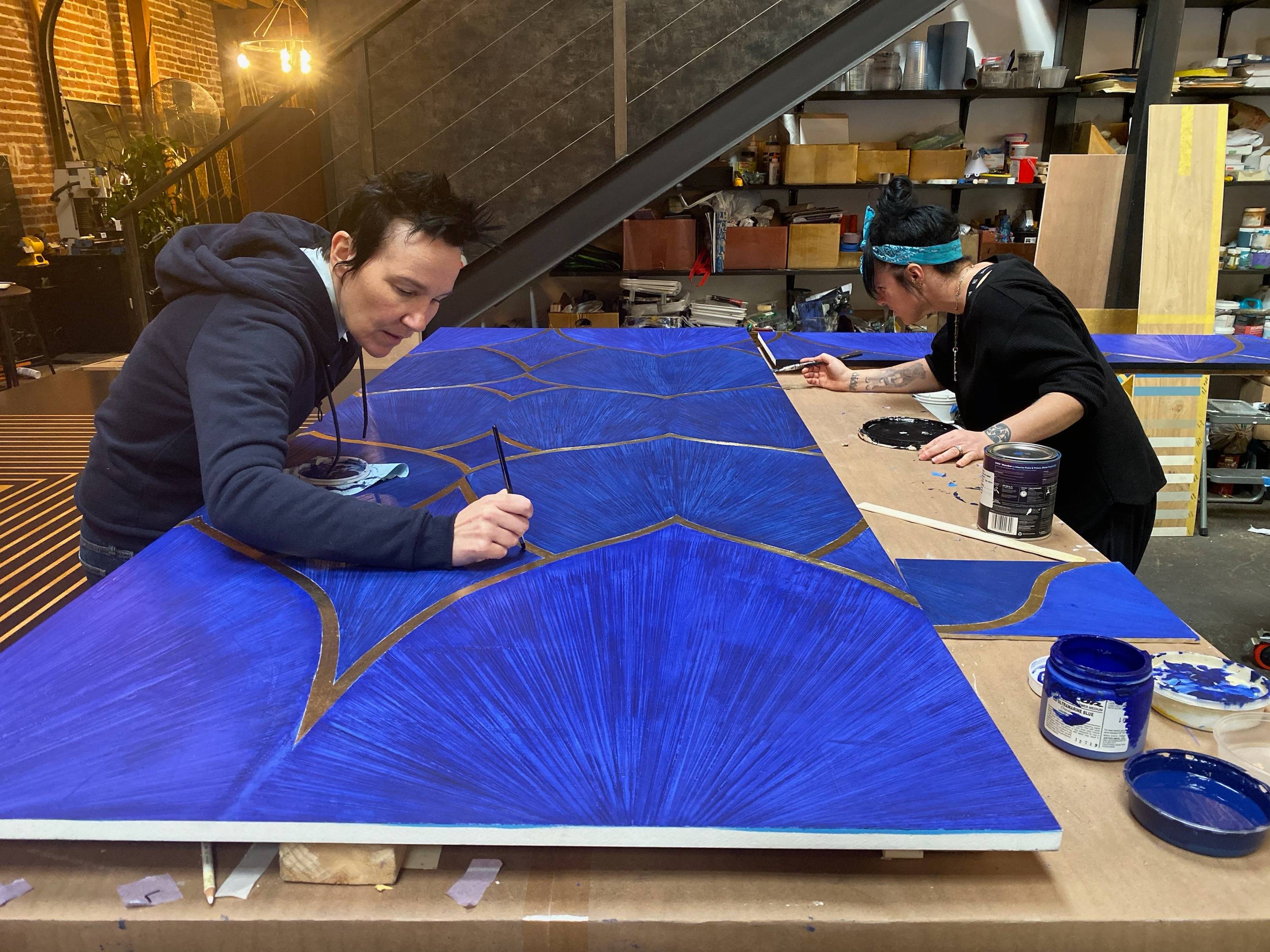 Brynn Gelbard and Lisa Donohoe of Londubh Studio put the finishing touches on the custom textured blue venetian plaster and 24 karat gold leaf 2020 Golden Globes Elevator set in their DTLA studio