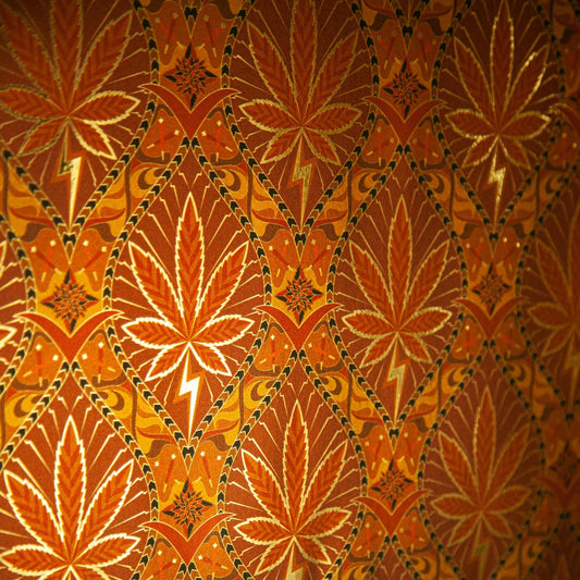 High Style High Class is a gothic revival inspired cannabis marijuana grass weed themed repeat pattern wallpaper featuring joints, buds, cannabis leaves, smoke motif, in metallic browns, coppers and oranges, all outlined in gold and digitally printed on gold mylar
