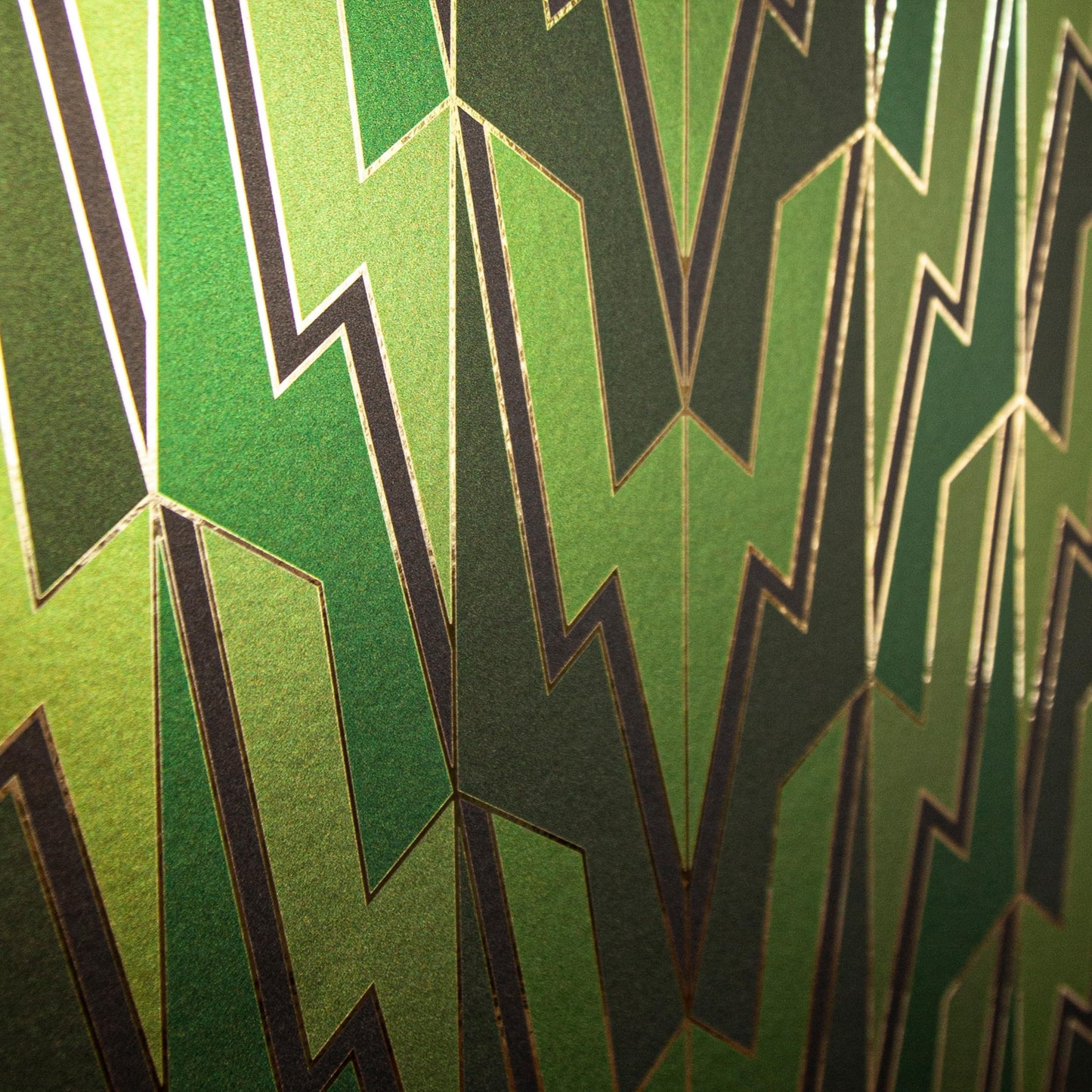 An angled close-up of the Greased Lightning wallcovering in a shimmering green and gold colorway.