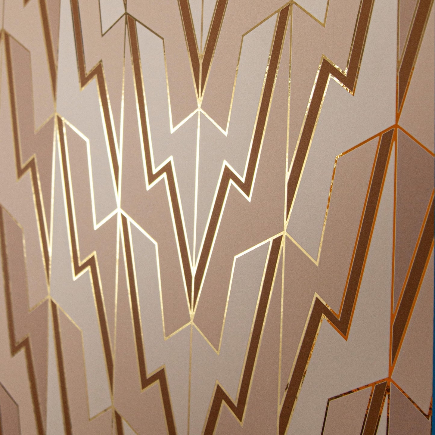 An angled shot of Greased Lightning 'Cream Dreams' wallcovering's Art Deco lightning pattern.