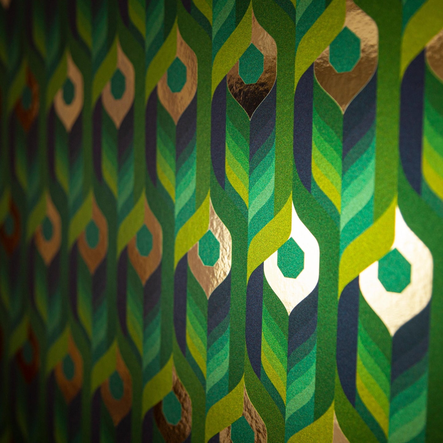 Neowise Tropical is a maximalist colorful repeat pattern wallpaper inspired by a comet that flew over Newgrange in Ireland and looks like a feather motif but is inspired by grain, and is tropical blues and greens, and gold, and printed on gold mylar - shown here at an angel with light illuminating the gold