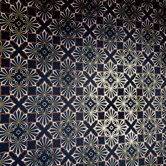 Blaze is a repeating geometric pattern featuring four cannabis and marijuana leaves digital printed on gold mylar shown in an angle to highlight the metallics