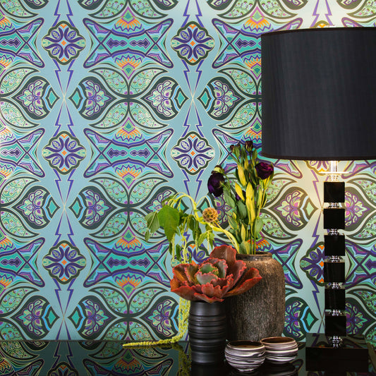 Ulu 'Garden' Wallcovering in vibrant botanical colors styled with a modern black lamp.