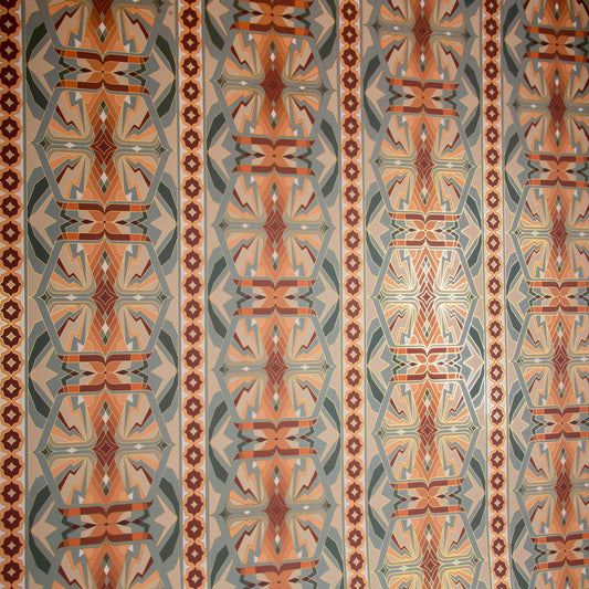 Sampa Terra is a riff of a classical vintage repeat linear geometric pattern wallpaper in earth tones, greens and oranges, with all shapes outlined in gold digitally printed on gold mylar shown at an angle with the light catching off the gold