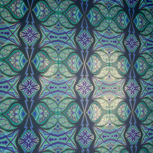 Ulu Canopy is a graphic repeat pattern featuring various organic motifs geometrically woven together in various greens and blues outlined in gold, digitally printed on gold mylar  and shown at an angle with the gold catching the light