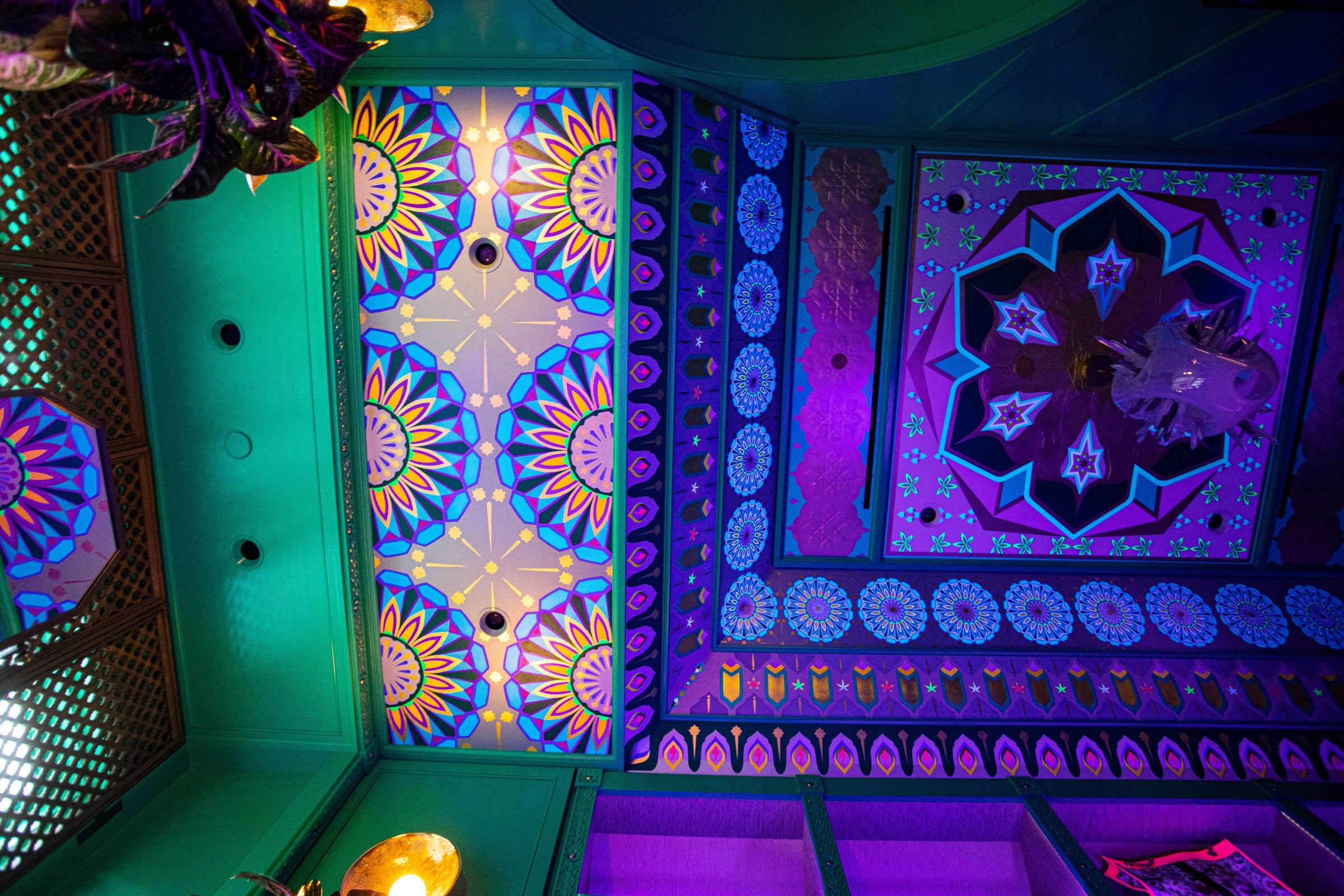 A vibrant, multi-patterned custom ceiling with a Star Guitar medallion in a maximalist space.