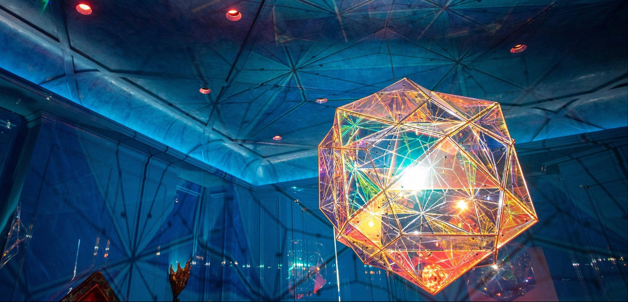 A geometric pendant light hangs from a blue ceiling with a Star Guitar pattern.