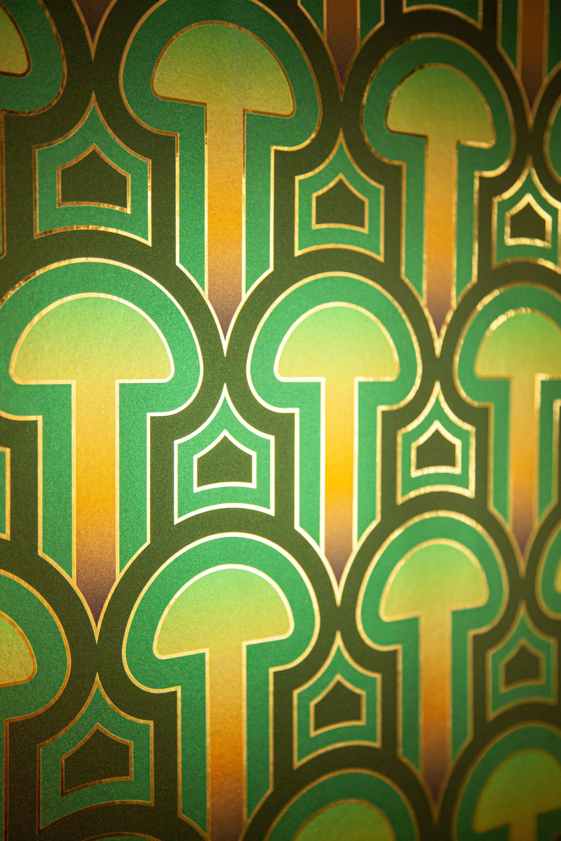 A detailed shot of the Enlightenment 'Psilocybe' Wallcovering's green and gold mushroom pattern.
