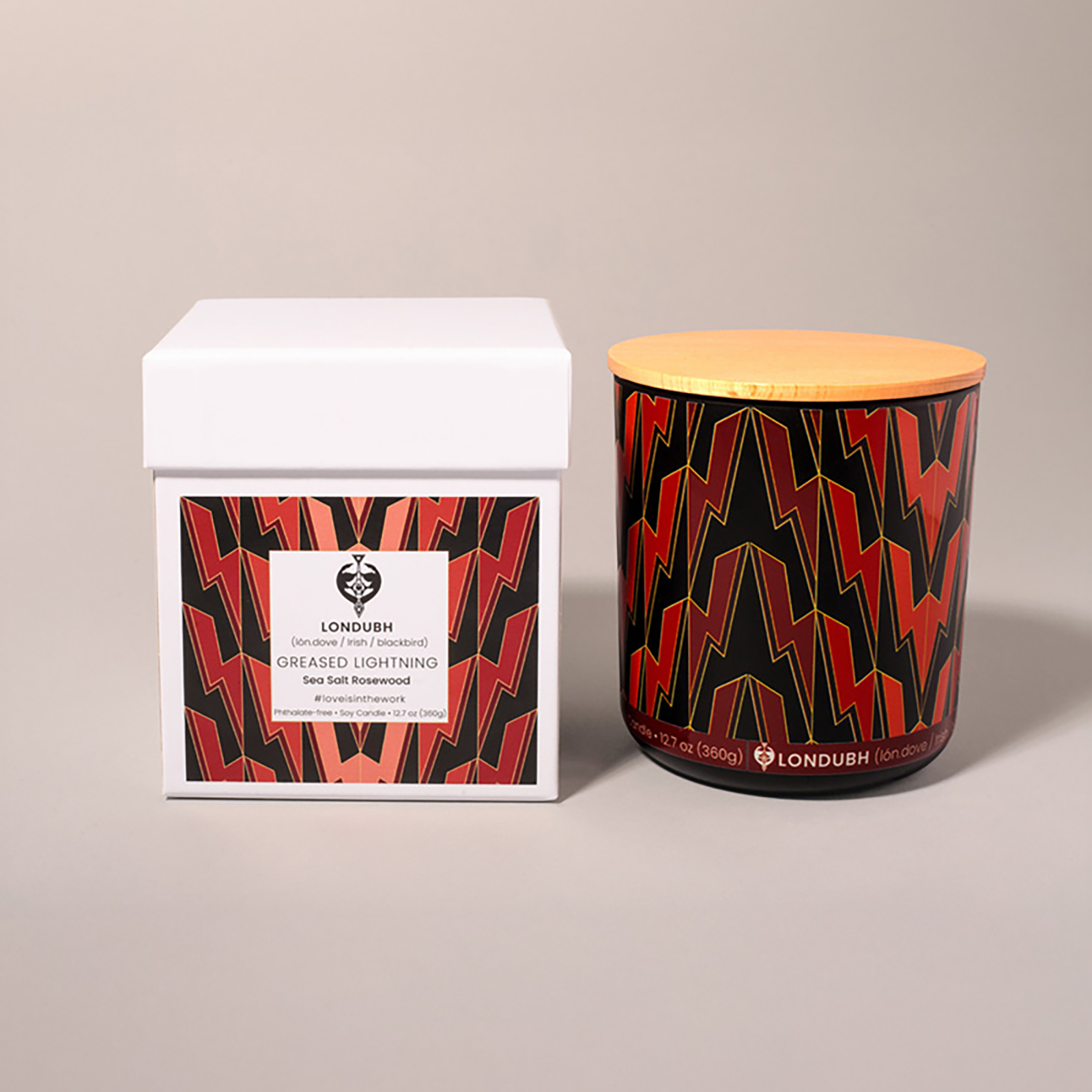 Greased Lightning Candle: Sea Salt Rosewood with a red and black Art Deco lightning pattern.