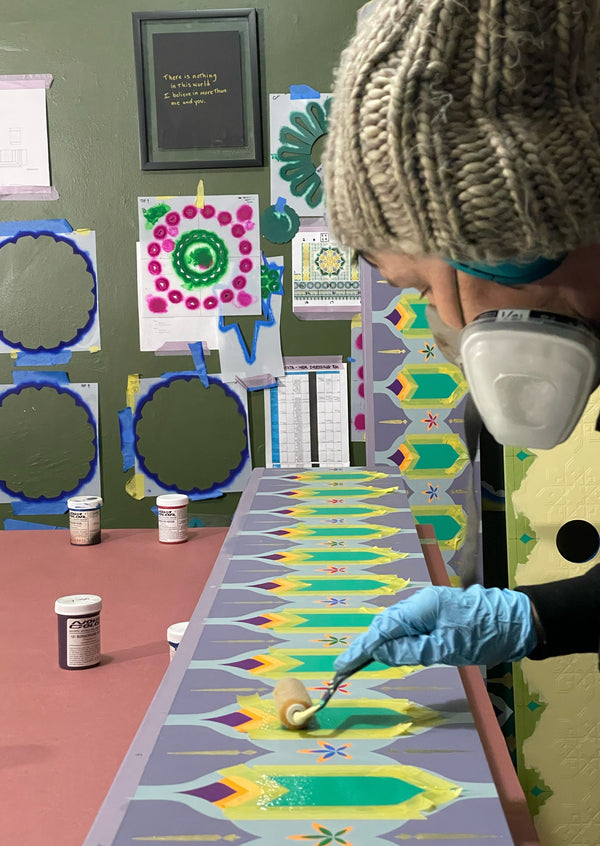 Applying size or adhesive in preparation to gild these Londubh heart motifs.