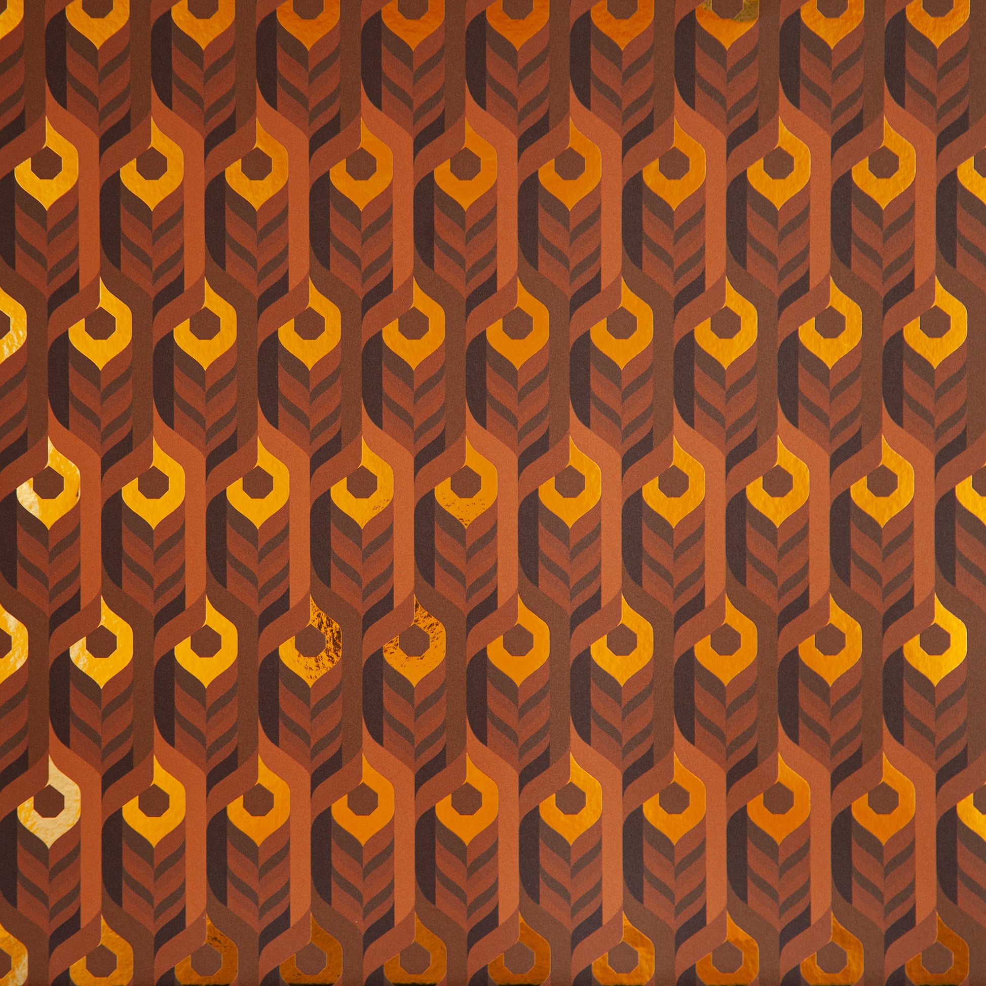 A close-up of the Integratronic 'Desert' Wallcovering shows its warm, 3D geometric pattern.