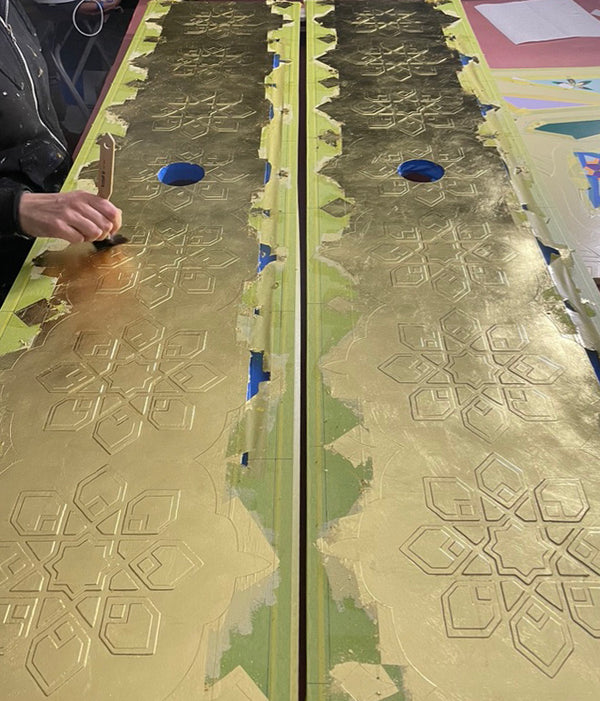 Skewing the 23 carat gold leaf after gilding the textured Londubh heart panels.