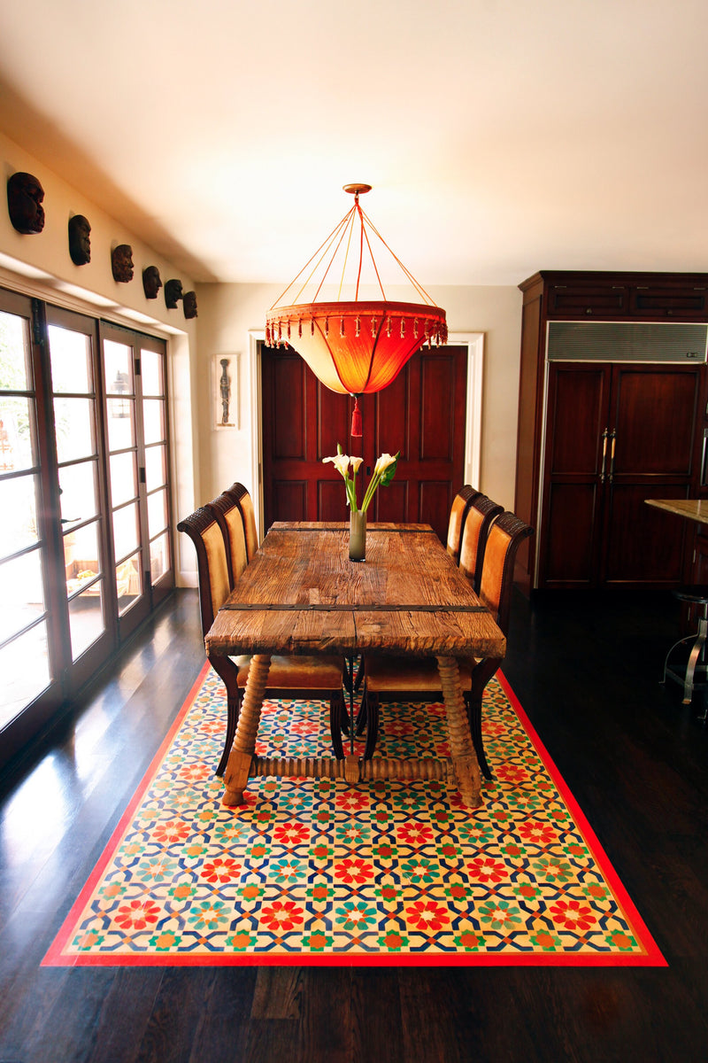 Dining room with a custom Moroccan-inspired geometric floor treatment in vibrant colors.
