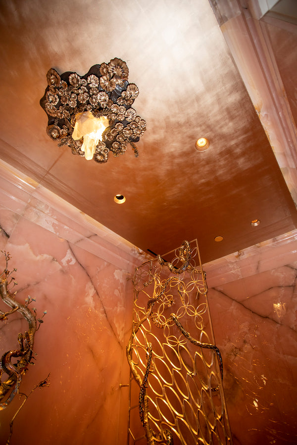 22-carat rose gold ceiling at the crown of one legendary powder room.