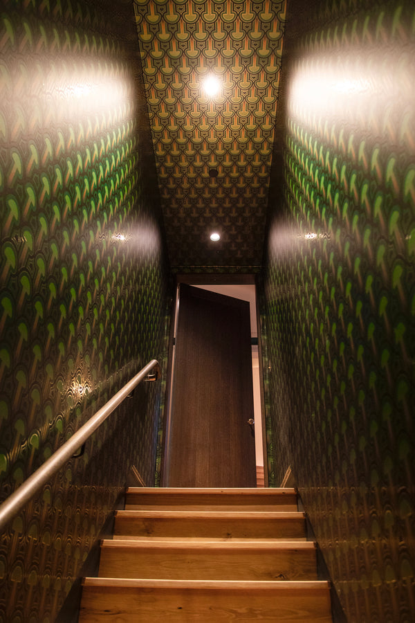 A view up the staircase lined in Londubh's Enlightenment Psilocybe wallcovering.