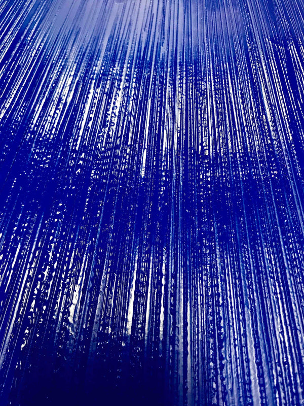 Detail shot of the custom blue plaster drying after being freshly textured.