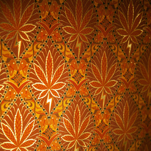 High Style High Class is a gothic revival inspired cannabis marijuana grass weed themed repeat pattern wallpaper featuring joints, buds, cannabis leaves, smoke motif, in metallic browns, coppers and oranges, all outlined in gold and digitally printed on gold mylar