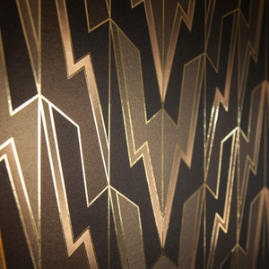 Greased Lightening Pink Sky at Night is a repeat art deco inspired gothamesque geometric pattern showcasing the lightning bolt, in black, grays, and thin pink to gray ombre, outlined in gold and printed on gold mylar