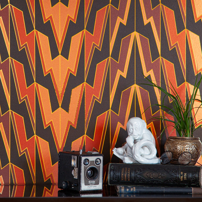 A vintage camera and porcelain monkey styled before Greased Lightning 'Power Of Love' wallcovering.