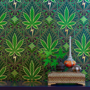 High Style Royal Highness is a gothic revival inspired cannabis marijuana grass weed themed repeat pattern wallpaper featuring joints, buds, cannabis leaves, smoke motif, in metallic greens, all outlined in gold and digitally printed on gold mylar - shown here in a vignette with incense holder and 33 records