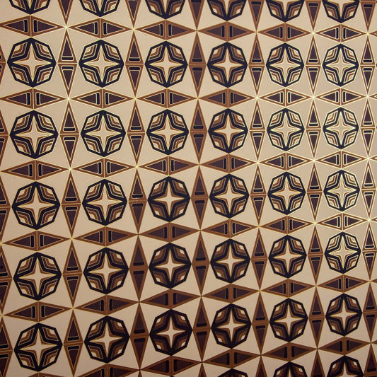 Integratronic Desert is a mid-century retro repeat geometric pattern featuring beiges and browns outlined in gold and digitally printed on gold mylar - shown at an angle with light illuminating the gold outlines