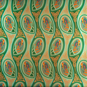 Peacock Nouveau Green Garden is a shimmering Celtic and Art Nouveau inspired maximalist repeat pattern wallpaper featuring peacocks and Celtic knot work in various greens, orange, blue, yellow, blues, purple, on a light green background, digitally printed on silver mylar 